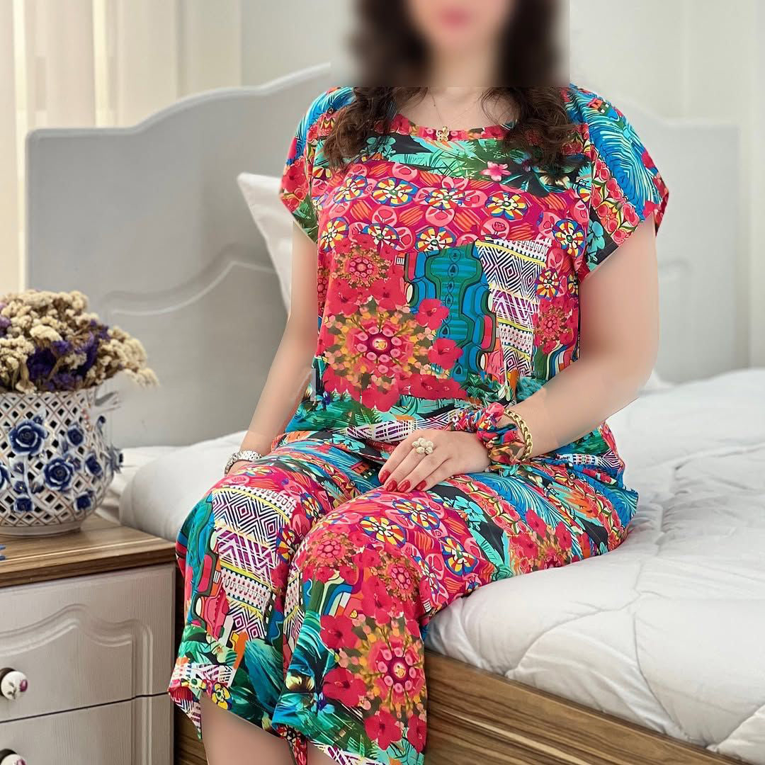 Colorful floral capri cord-set with short-sleeve top and matching capri pants, seated