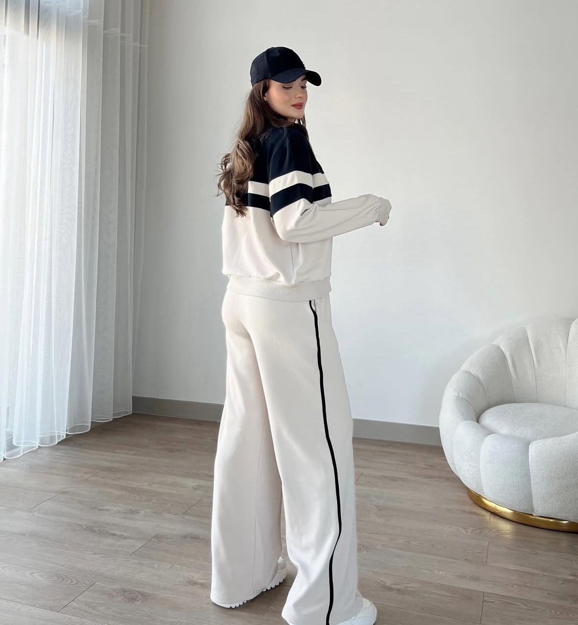 Zip-up track jacket and wide-leg pants set, side view with white panel stripes