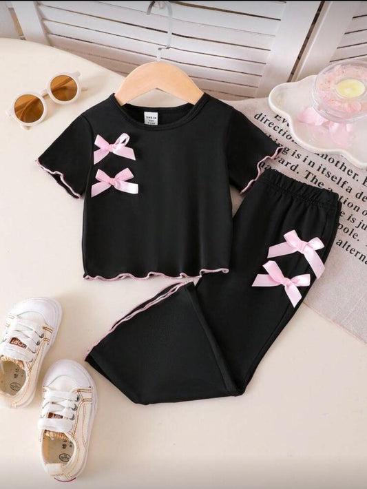 Black baby outfit set with pink bows on short-sleeve top and pants with trim