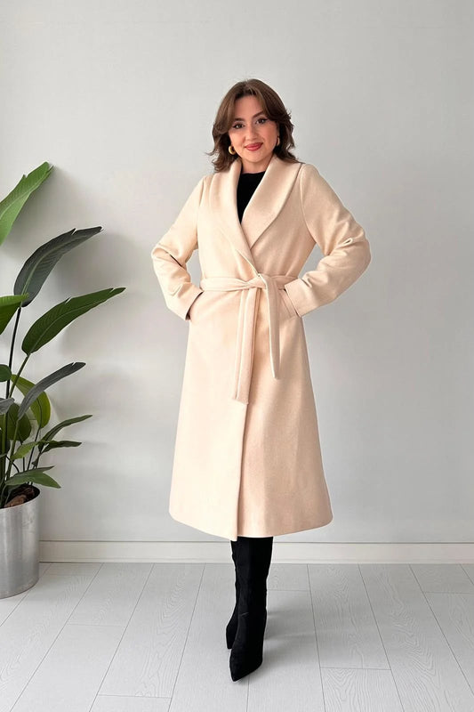 Beige belted long coat with wide lapel collar and waist tie, front view.