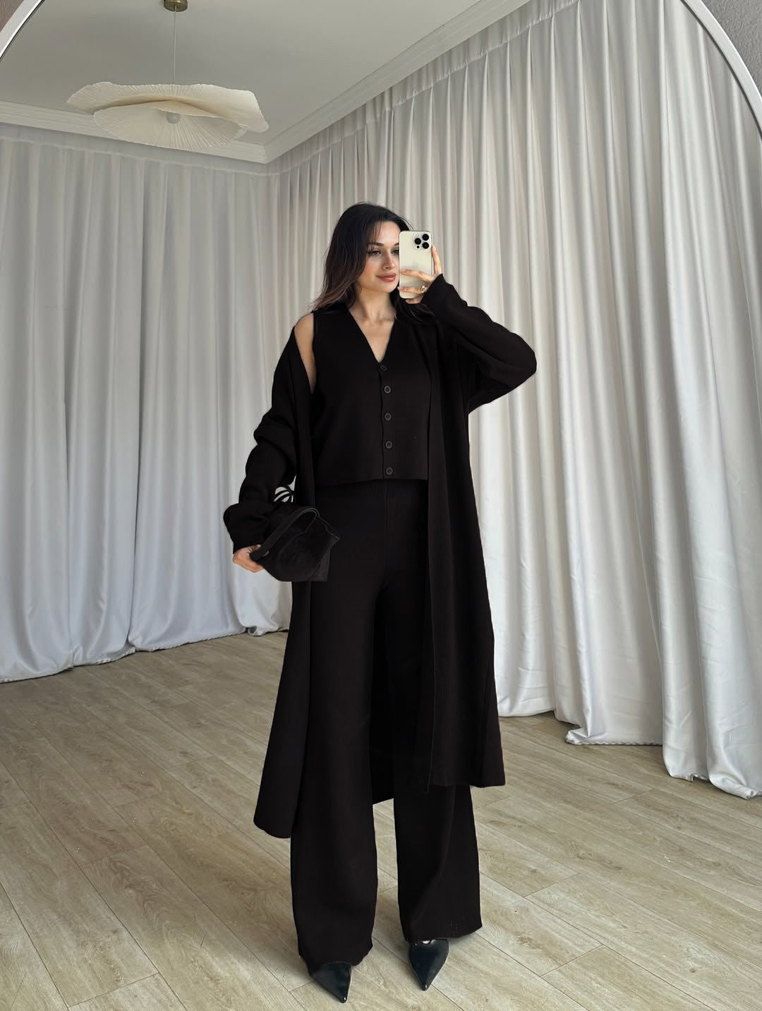 Black 3-piece co-ord: long button coat, sleeveless top, wide-leg trousers