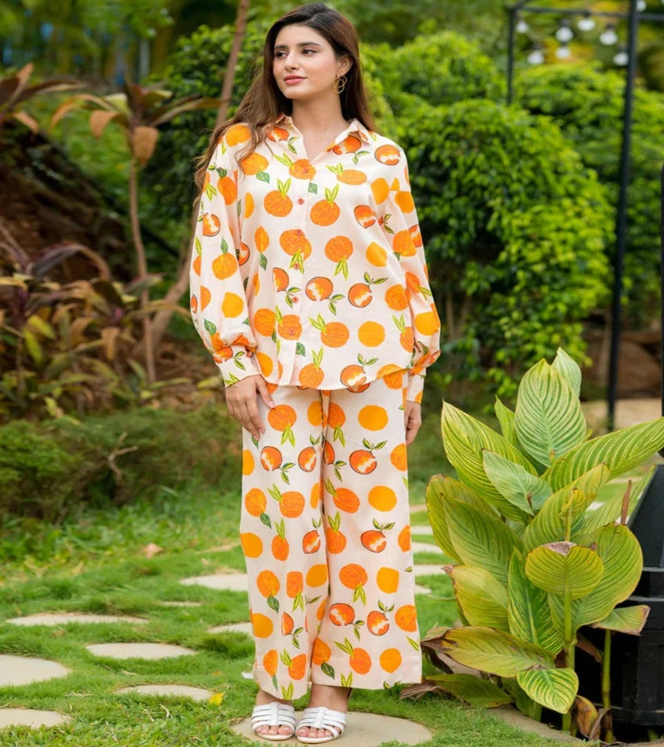 KAREN co-ord set in white with orange fruit print, long-sleeve top and wide-leg pants