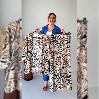Zebra-print kimono top and wide-leg trousers set, draped on hangers