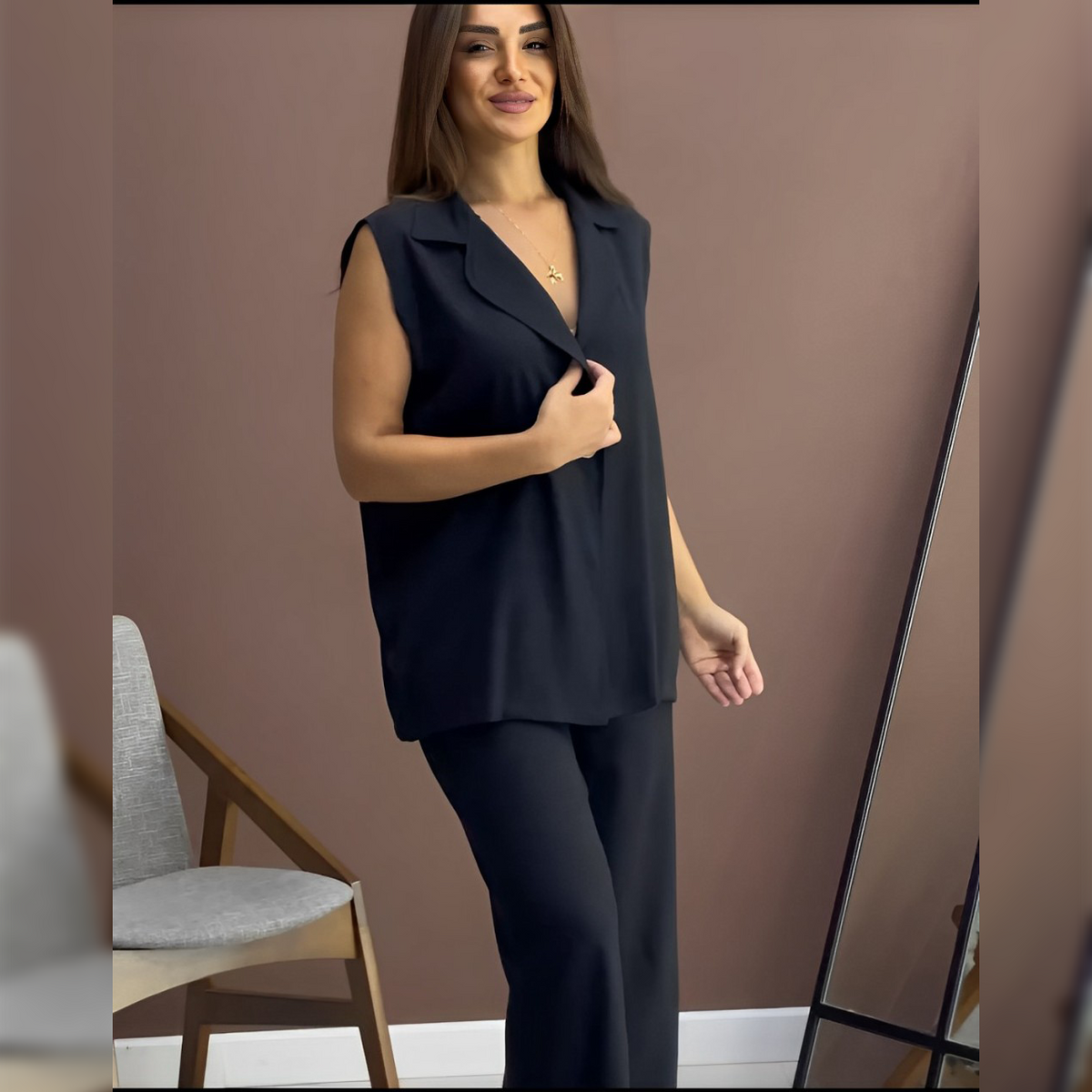 Sleeveless co-ord set with dark button-up sleeveless top and matching fitted pants