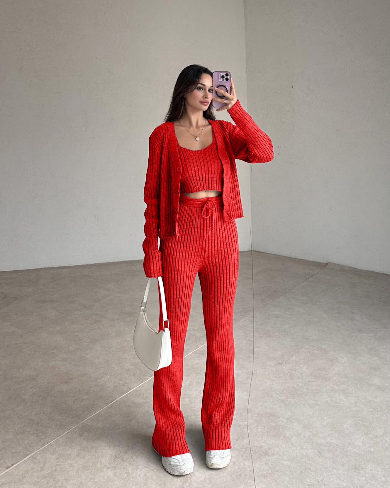 Red ribbed knit set with cropped top, cardigan, and high-rise straight pants.