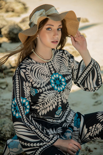 Long maxi dress in black with white botanical pattern and teal accents, round neckline