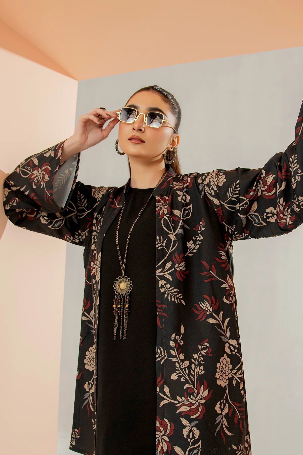 Black floral long jacket outfit with gold tassel necklace and matching pants