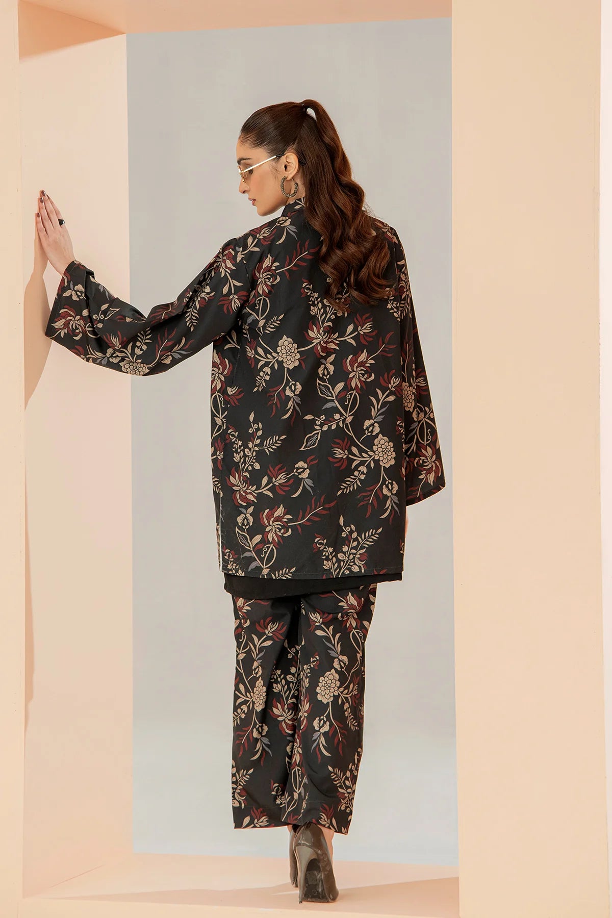 Floral black suit set with long jacket and tapered pants, side profile