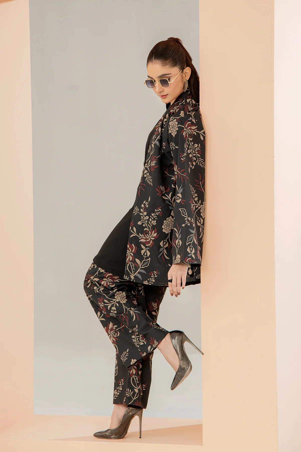 Floral black long jacket and tapered pants with mid-calf length, side pose
