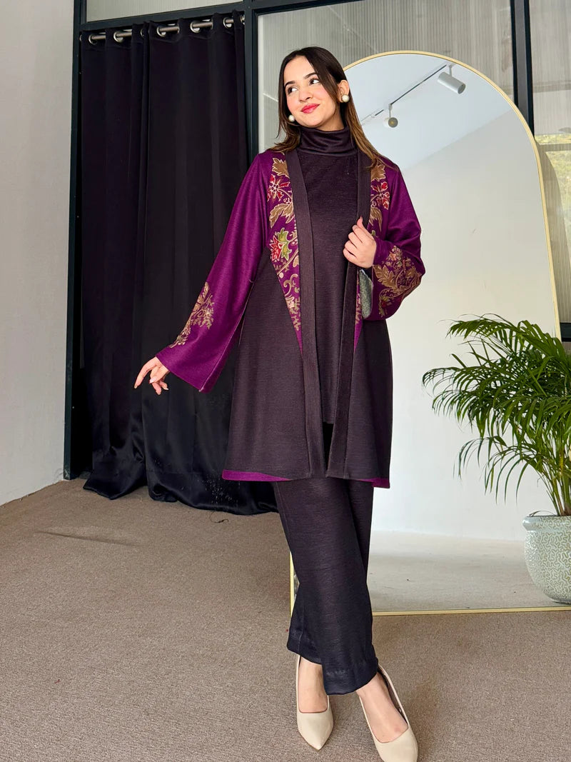 Two-tone long tunic with purple embroidered sleeves over dark top, paired with dark leggings