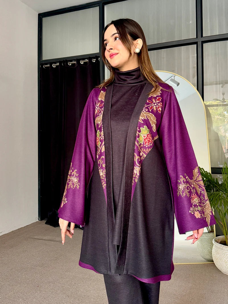 Two-tone tunic with purple patterned edges over dark turtleneck and dark leggings