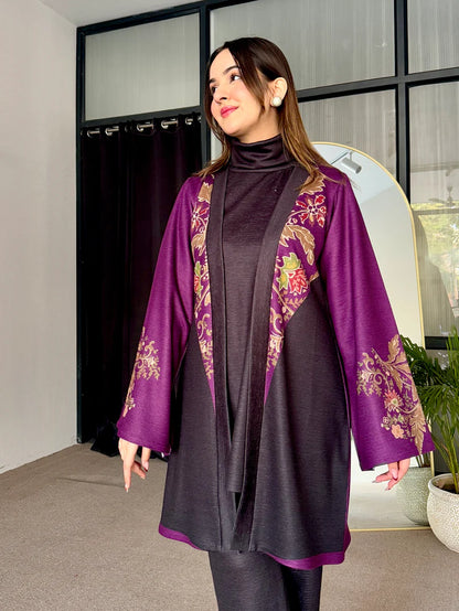 Two-tone tunic with purple patterned edges over dark turtleneck and dark leggings