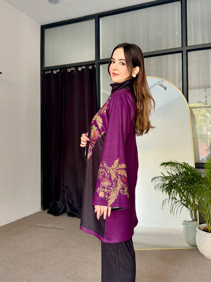 Two-tone long tunic with purple embroidered sleeves, dark leggings, and turtleneck