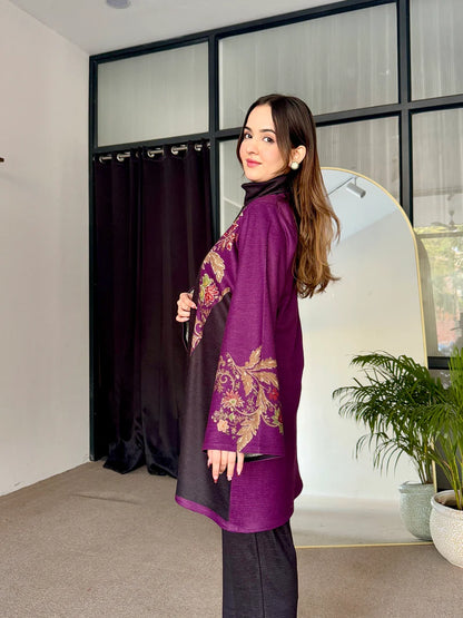 Two-tone long tunic with purple embroidered sleeves, dark leggings, and turtleneck