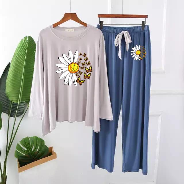 Women's loungewear set with light grey long-sleeve top and blue pants, daisy floral print.