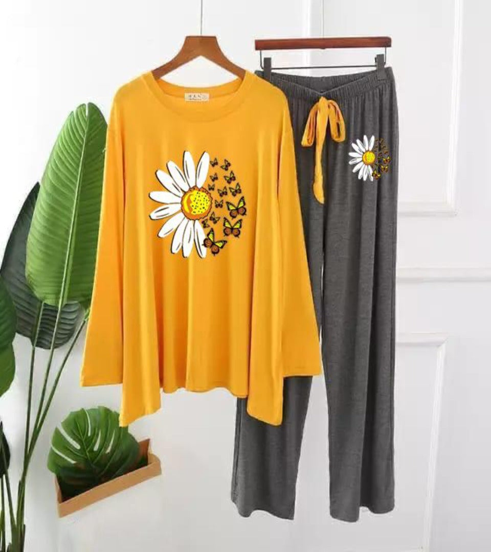 Women's loungewear set with yellow long-sleeve top and grey pants, daisy print.