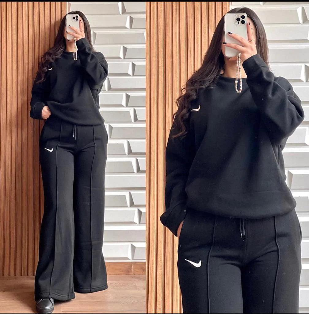 Black two-piece lounge set with hooded sweatshirt and wide-leg pants, drawstring waist, front view.