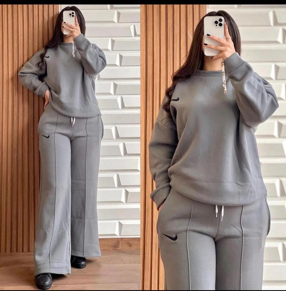 Grey two-piece lounge set with hooded sweatshirt and wide-leg pants, drawstring waist.
