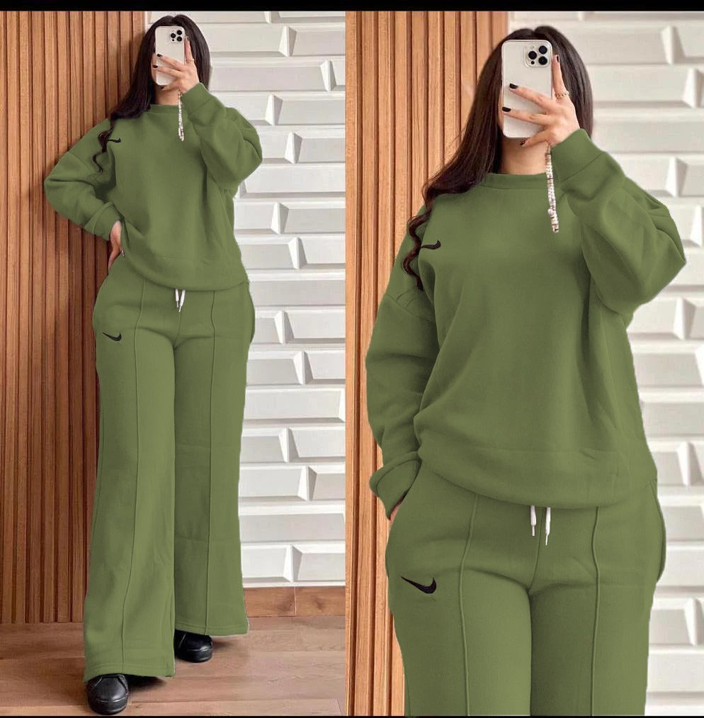 Green two-piece lounge set with hooded sweatshirt and wide-leg pants, drawstring waist.