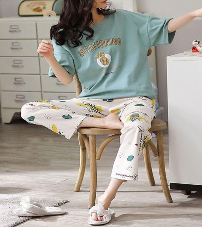 Sky blue pajama set: short-sleeve tee and patterned lounge pants, seated on chair