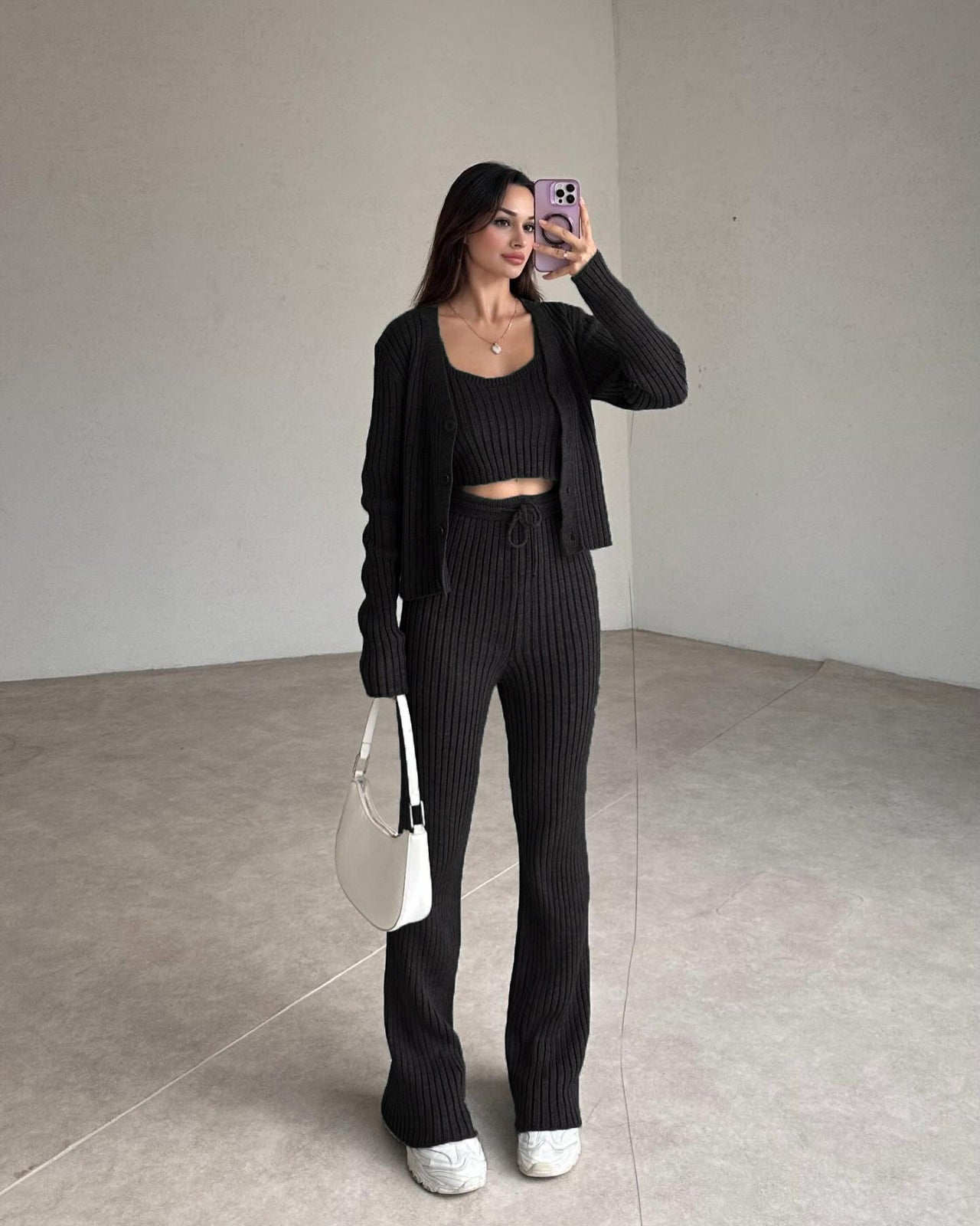 Black ribbed knit set with cropped top, cardigan, and high-rise straight pants.