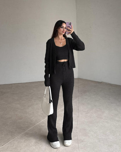 Black ribbed knit set with cropped top, cardigan, and high-rise straight pants.