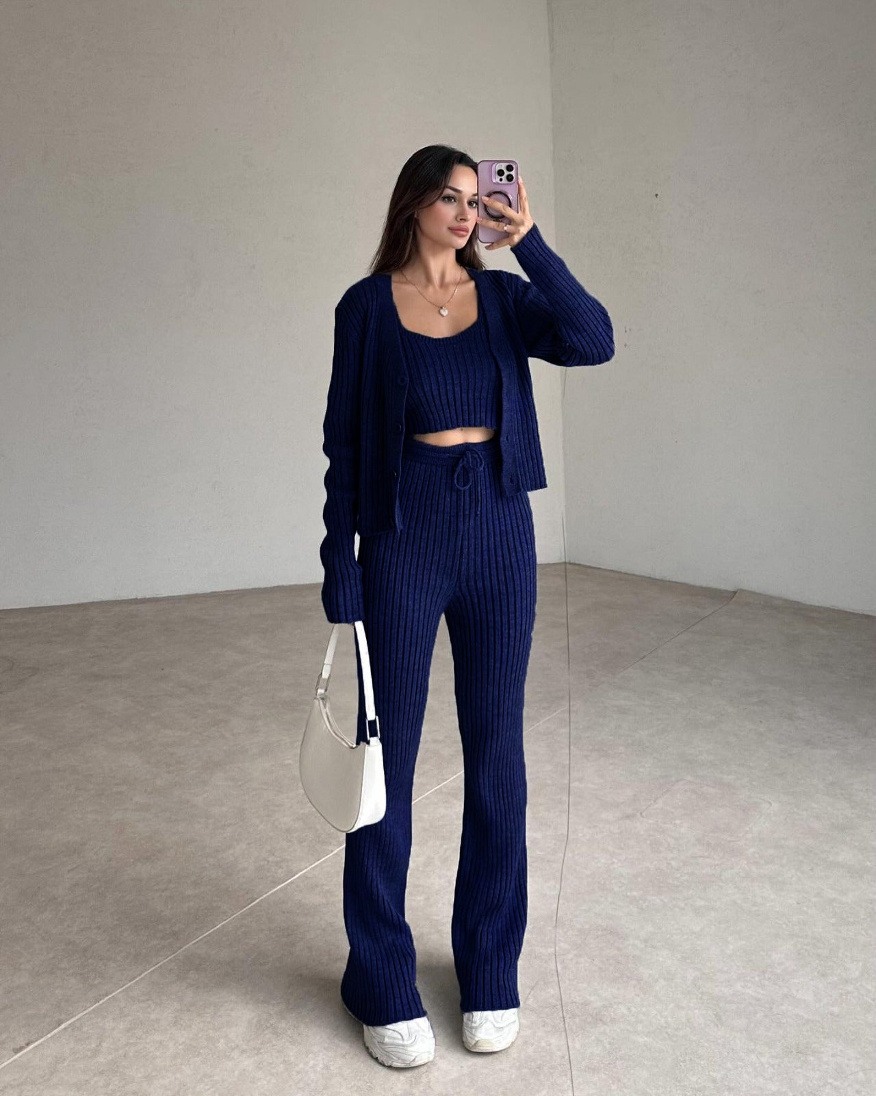 Navy ribbed knit set with cropped top, cardigan, and high-rise straight pants.