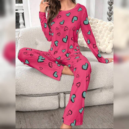 Pink heart-print long-sleeve PJ set with wide-leg long pants, lounge pose