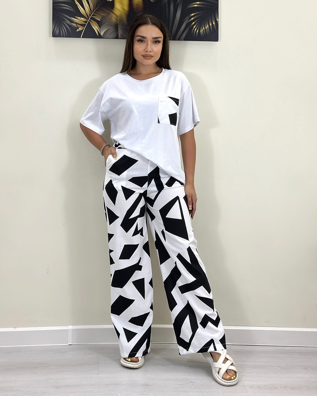 White short-sleeve T-shirt with black patch pocket and black-and-white wide-leg pants