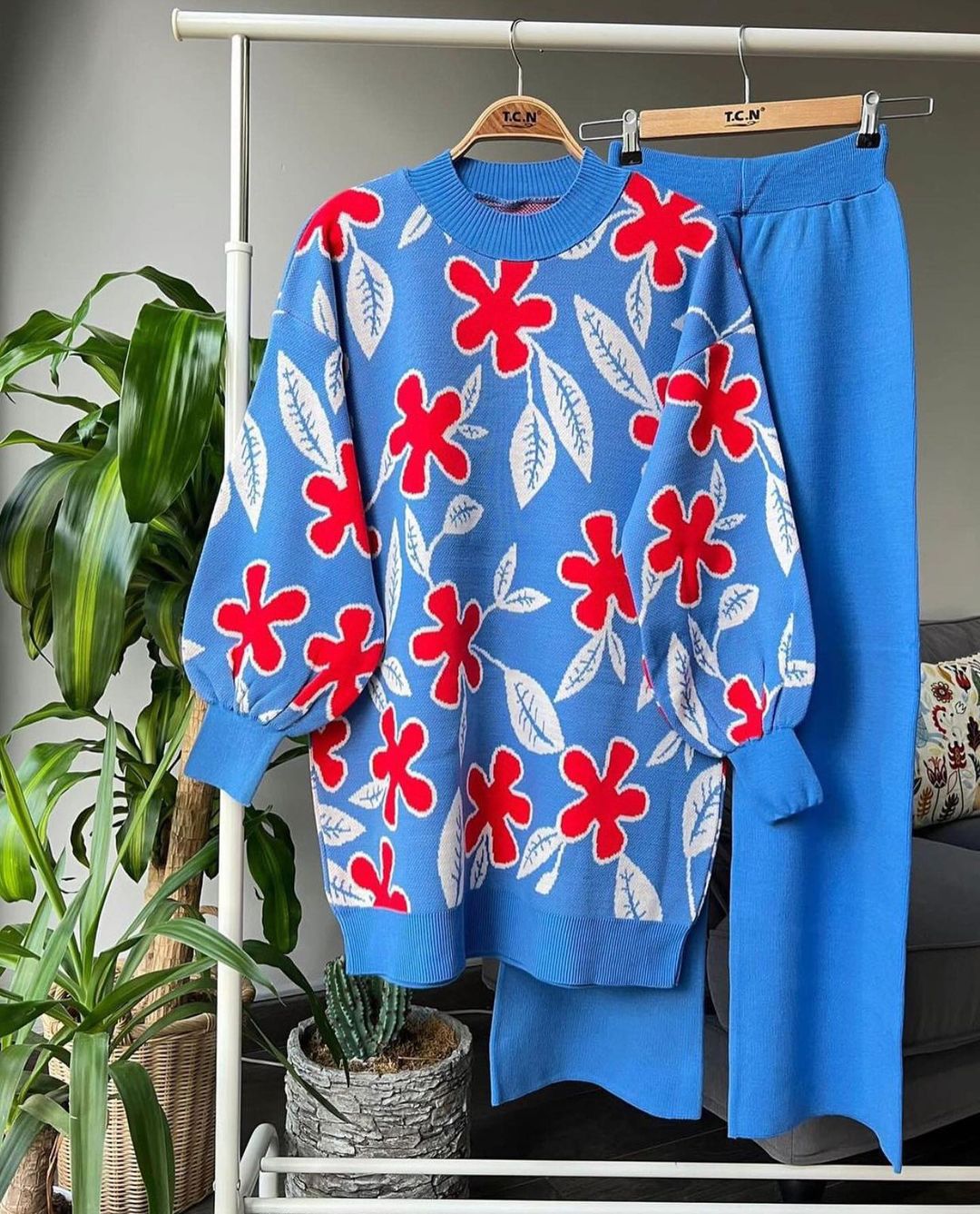Blue leaf knit sweater with red floral motifs and matching blue trousers