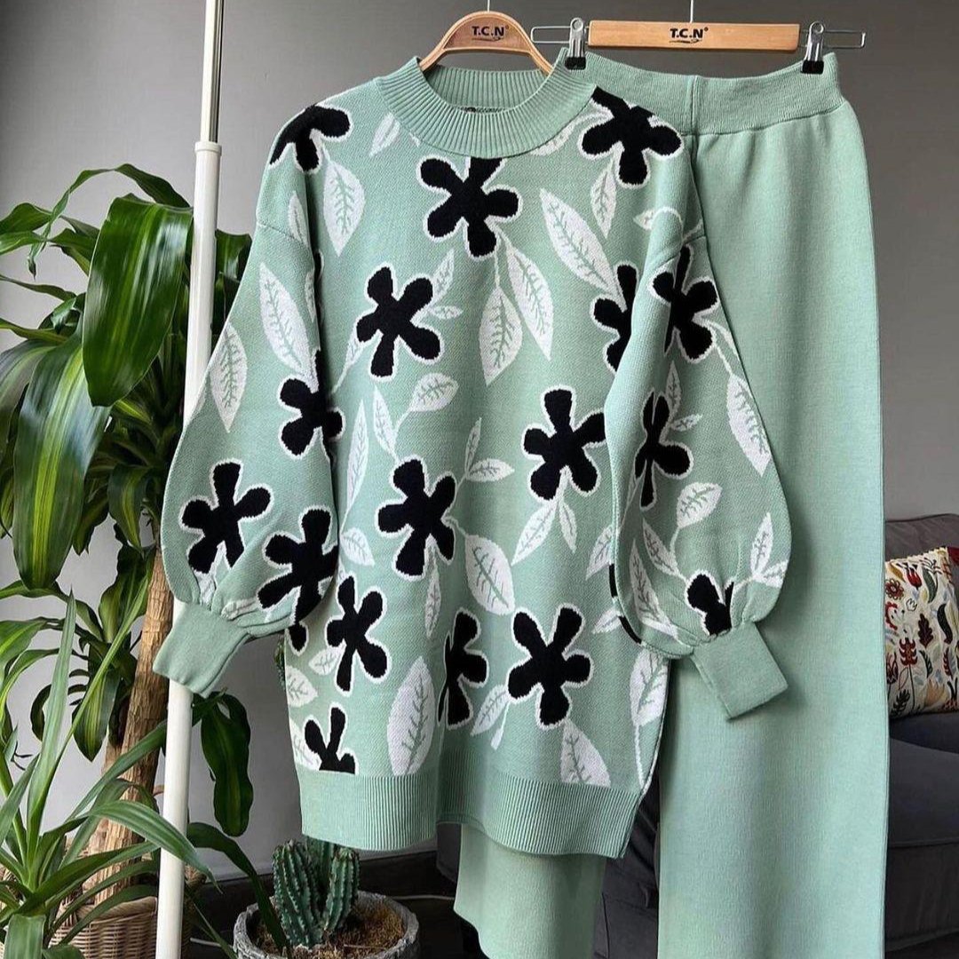 Light mint leaf knit sweater with black floral motifs and matching mint trousers
