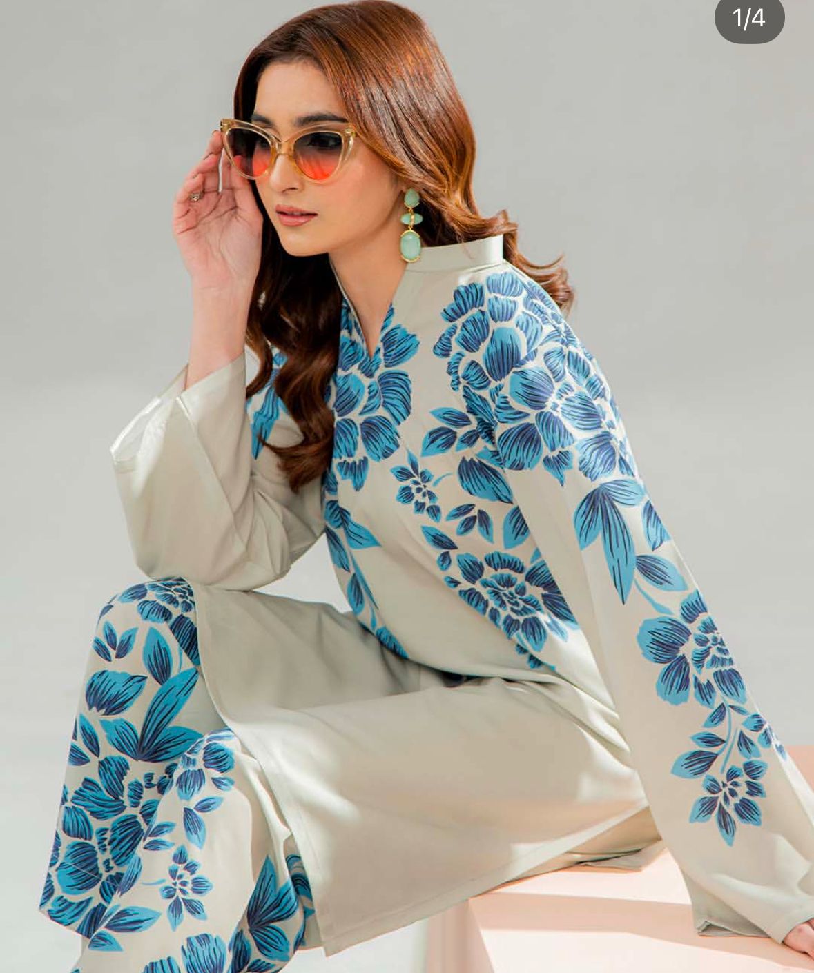 Cord set tunic with blue floral print and matching wide-leg pants, close-up.
