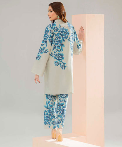 Cord set with long tunic and pants, cream with blue floral print, back view.