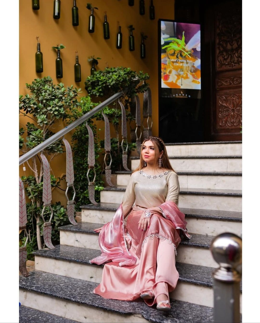 Beige long dress with gold embroidery, pink skirt panel, and draped dupatta