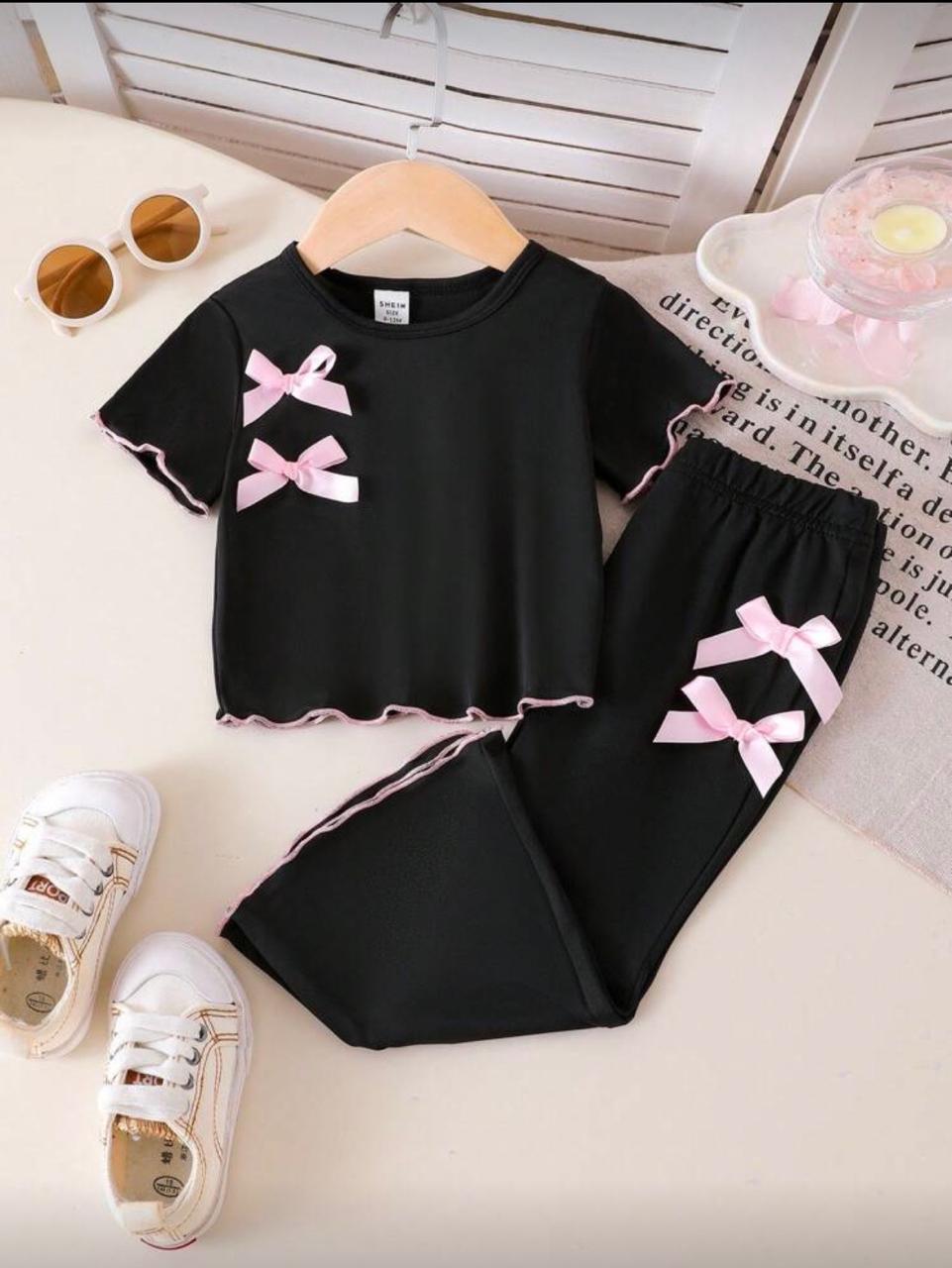 Black baby outfit set with pink bows on short-sleeve top and pants with trim