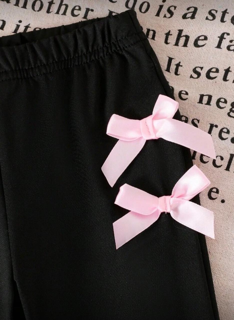 Black pants with pink ribbon bow detail and gathered elastic waistband