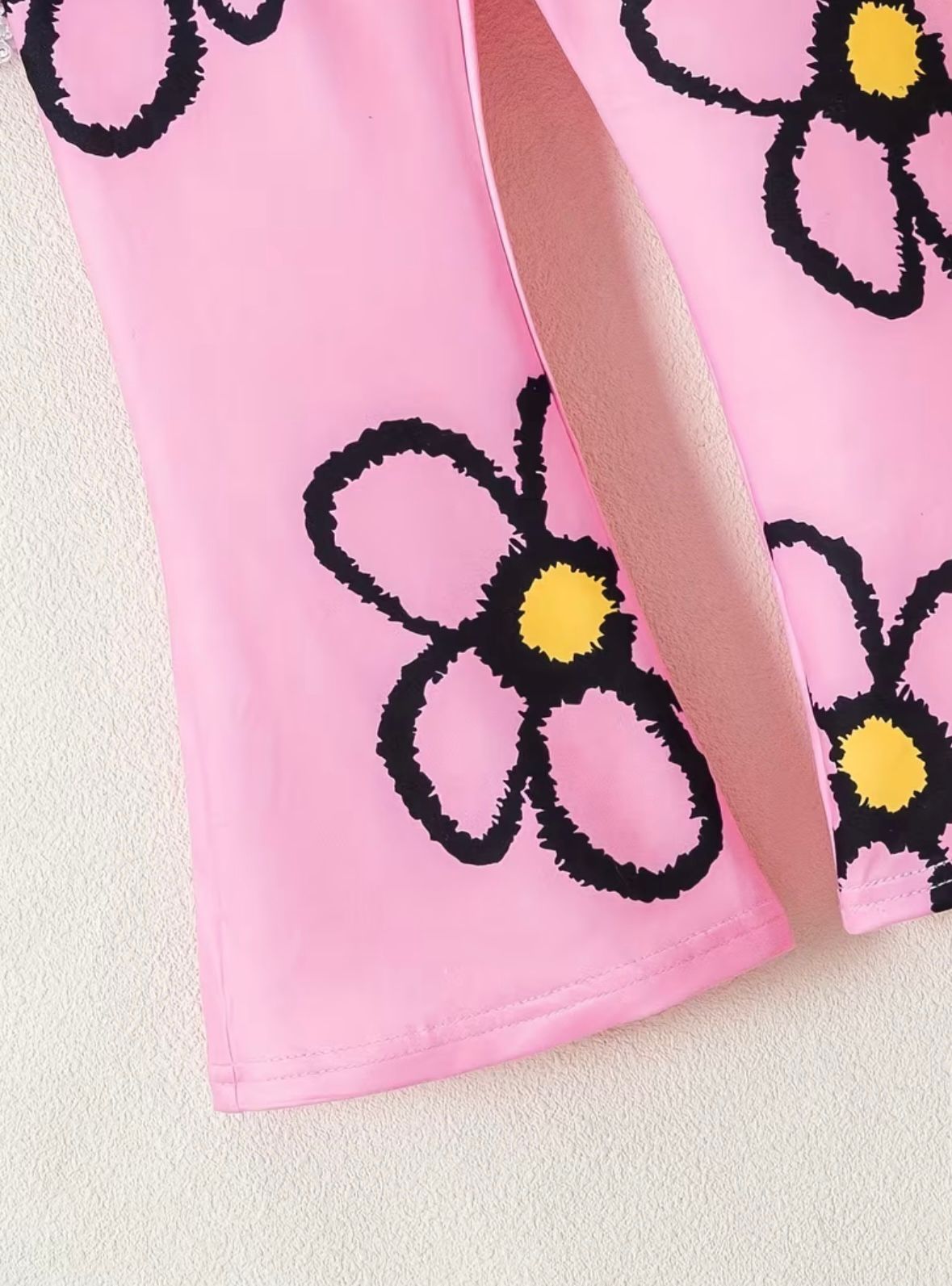 Floral round-neck top, pink fabric with black-outlined flower prints