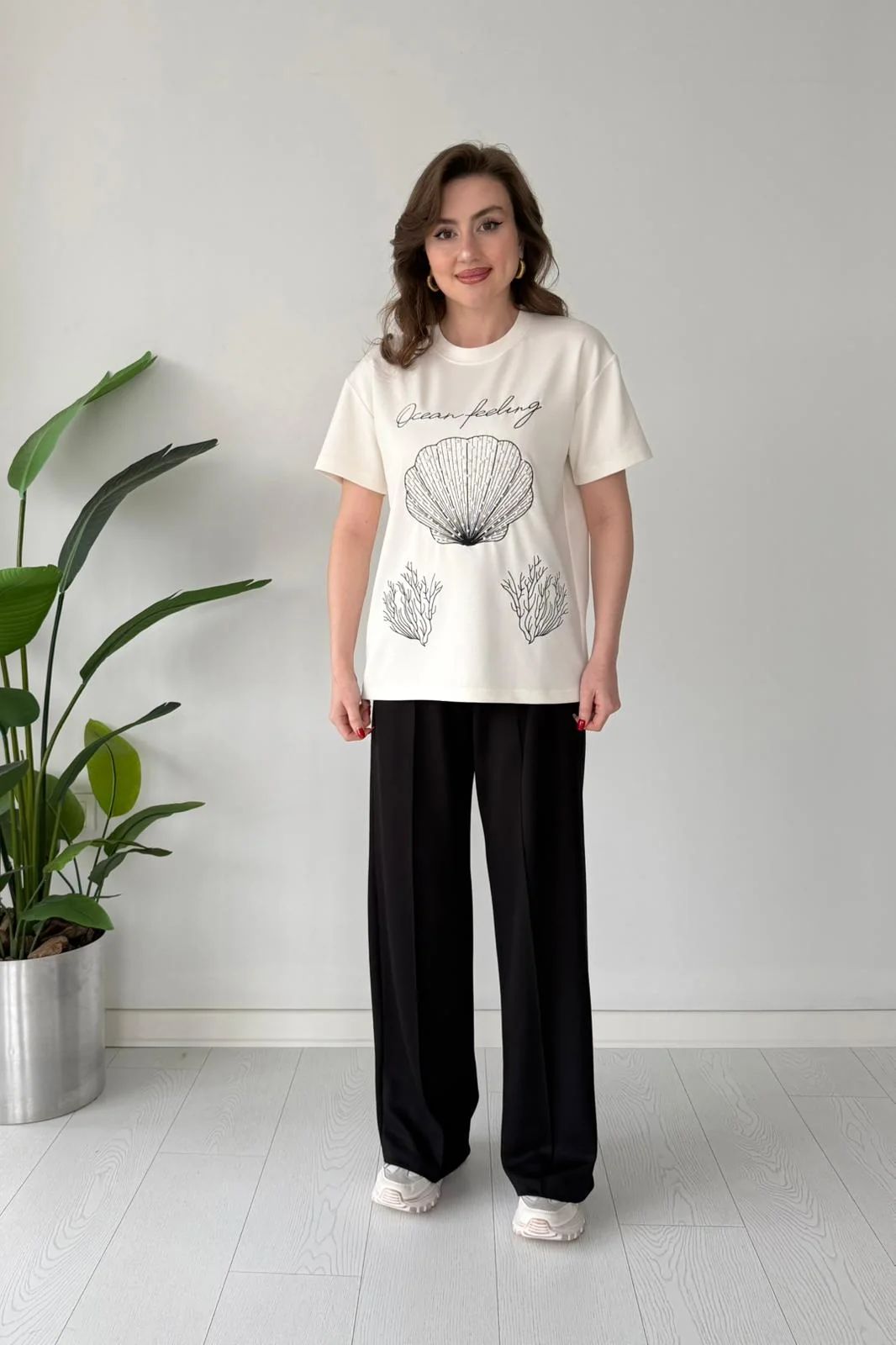 Printed cord set with white shell graphic T-shirt and black wide-leg pants