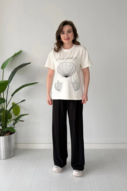 Printed cord set with white shell graphic T-shirt and black wide-leg pants