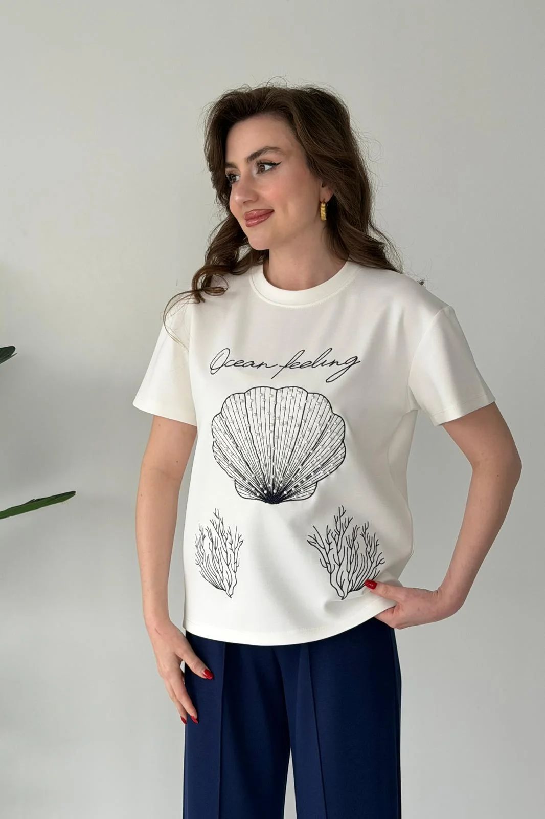 Printed cord set with white shell graphic T-shirt and navy blue wide-leg pants, close-up