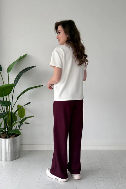 Printed cord set with white shell graphic T-shirt and maroon wide-leg pants