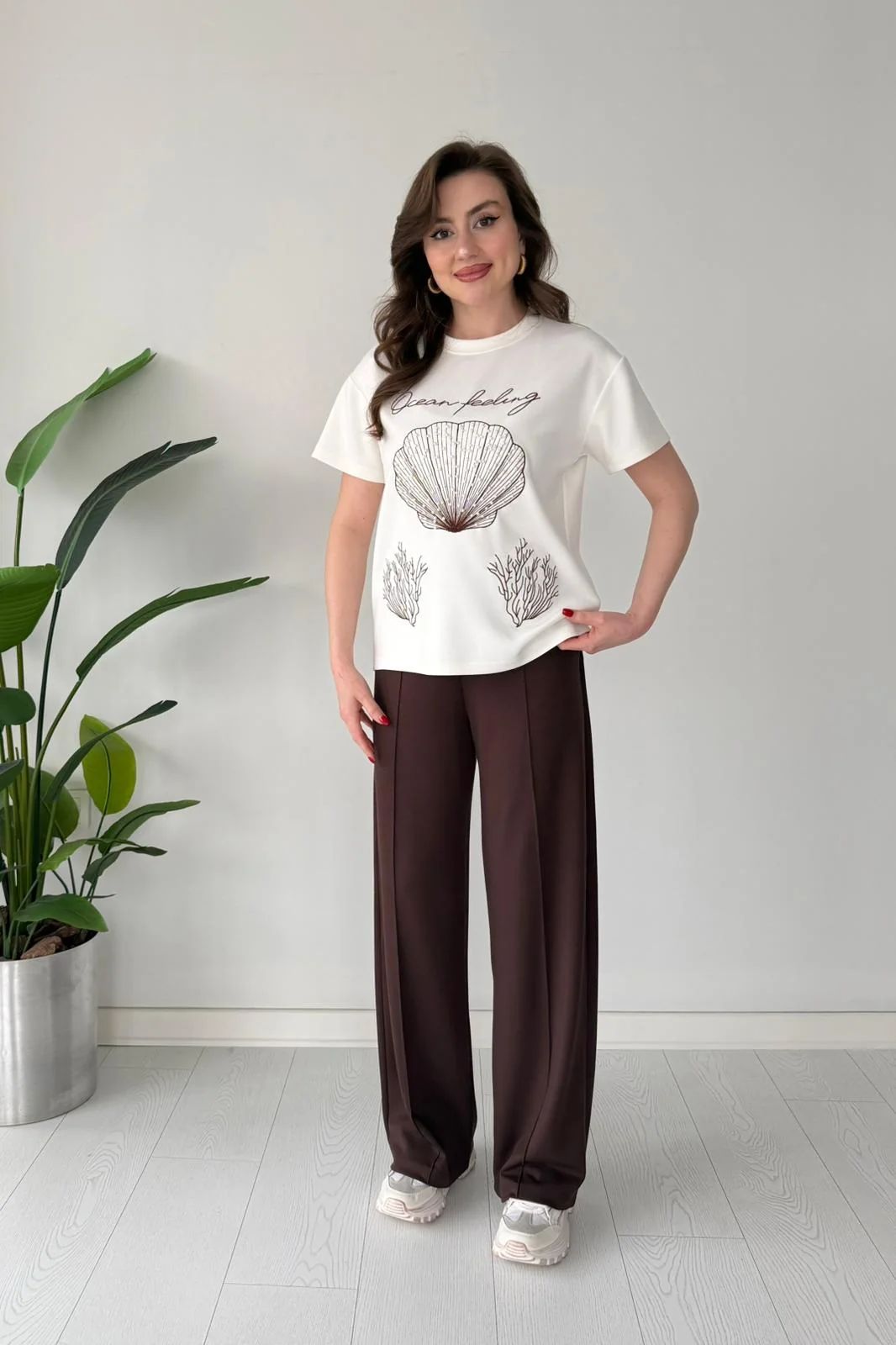 Printed cord set with white shell graphic T-shirt and dark brown wide-leg pants