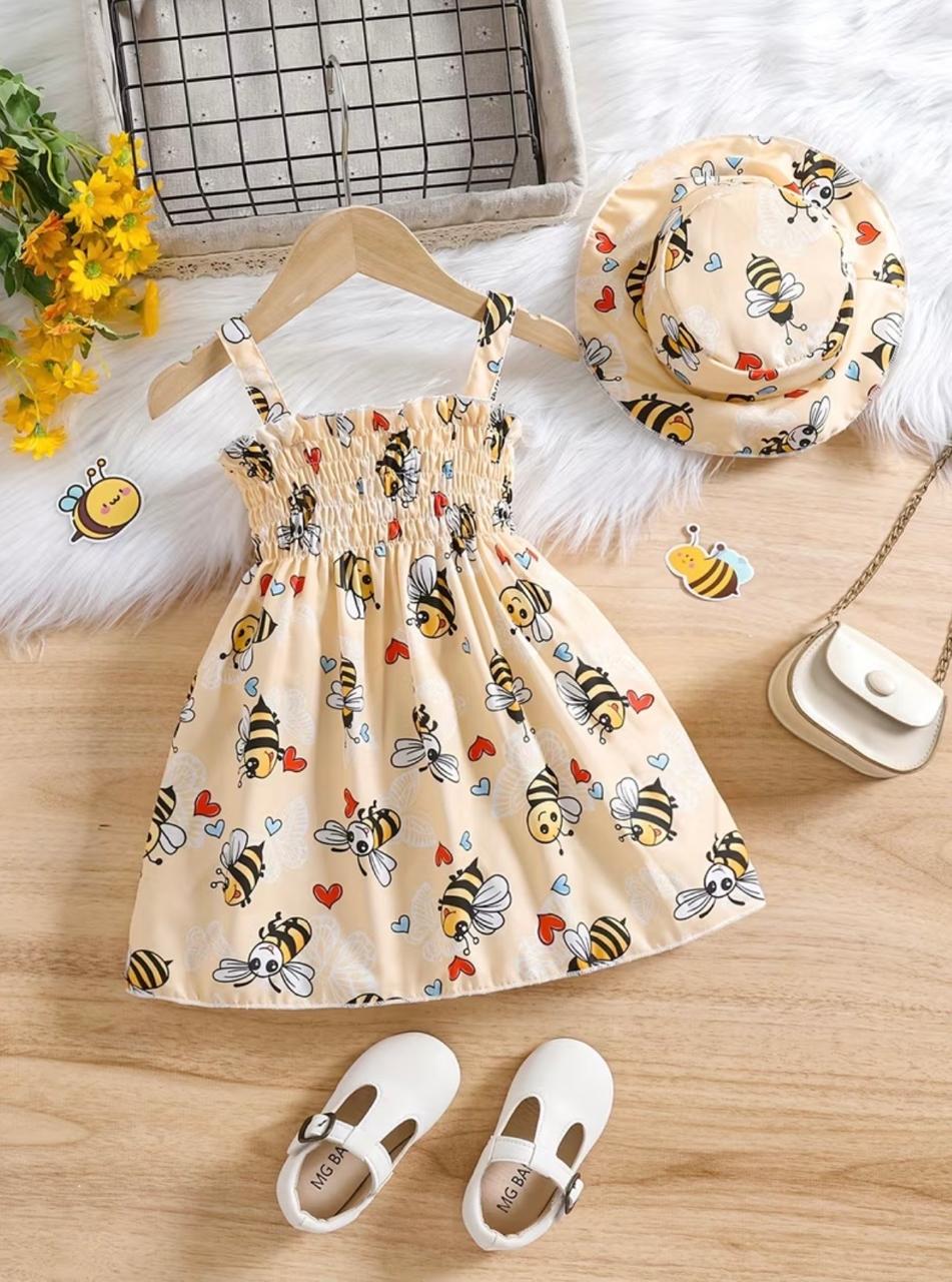 Bee print frock with gathered skirt, matching hat and white shoes