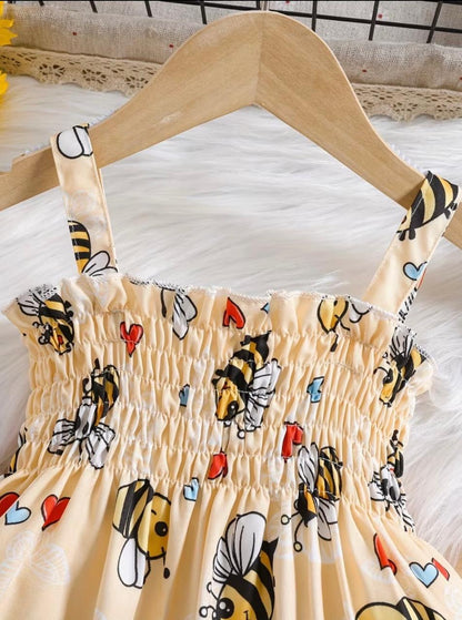 Honey-colored bee print smocked frock with puff sleeves and elastic shoulder straps