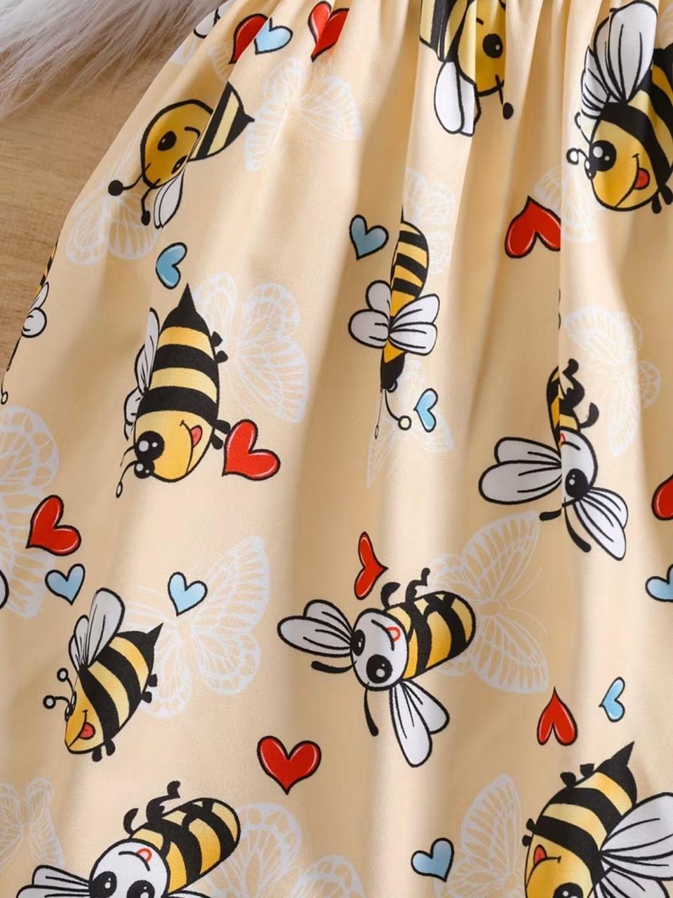 Butter-yellow bee pattern frock fabric with hearts and bow motifs