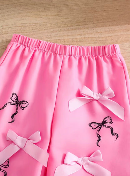Pink bow set shorts with elastic waist and white ribbon bows, black silhouette accents