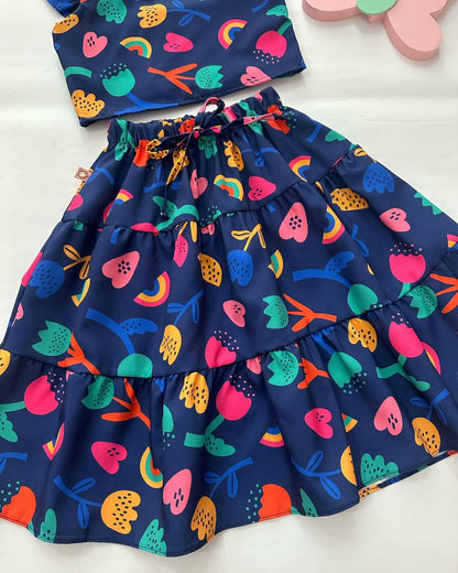 Navy tiered skirt with elastic waistband and colorful fruit and rainbow print