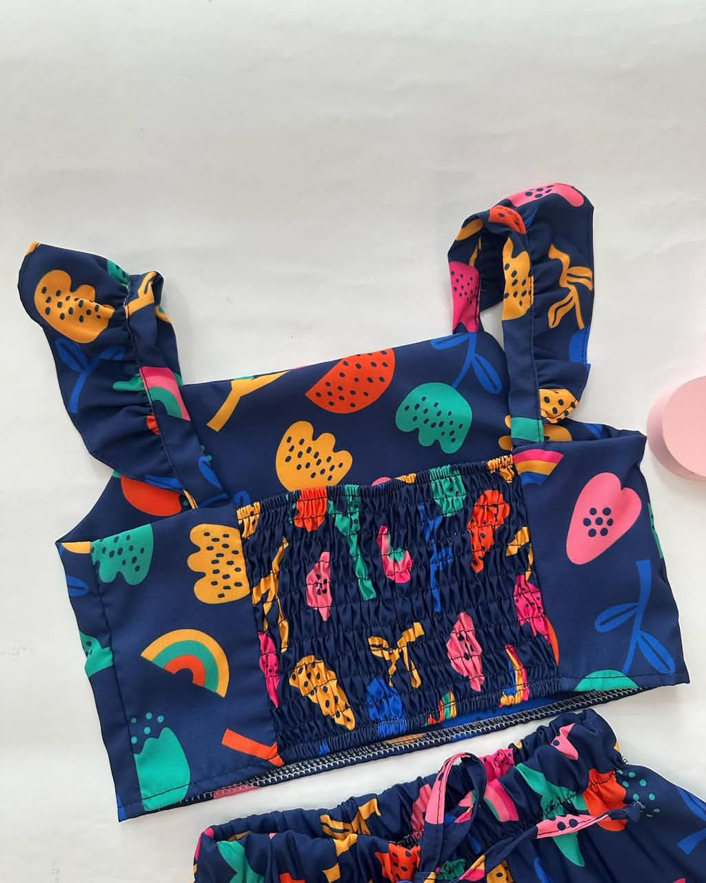 Navy tiered skirt with gathered smocked bodice and colorful fruit and rainbow print