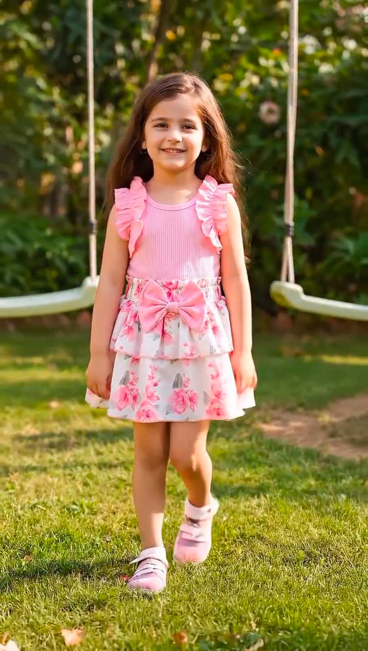 Girls' pink sleeveless ruffle dress with floral tiered skirt, front view