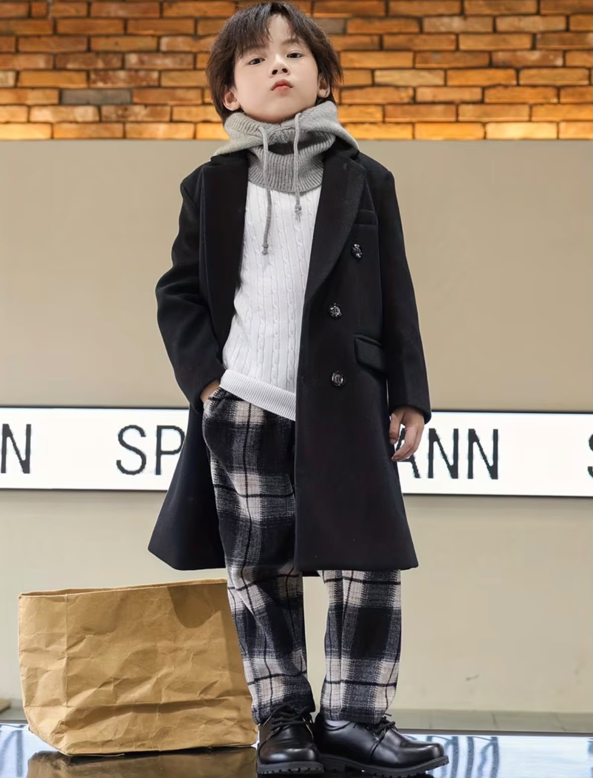 Vintage black trench coat with notched lapels and double buttons, worn over plaid pants
